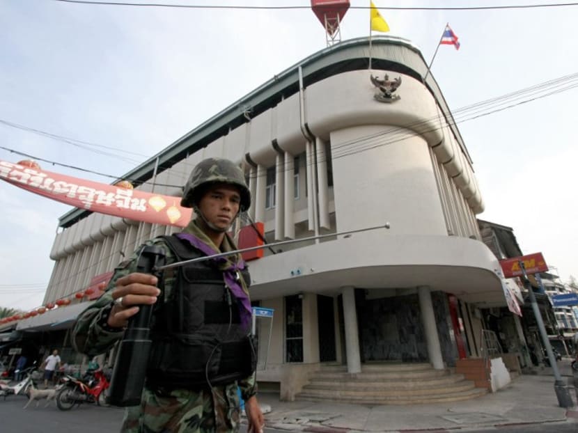 This file picture taken on March 2, 2010 shows a Thai soldier using a GT200 detector as he patrols the streets of Yala, in Thailand's restive south. Photo: AFP