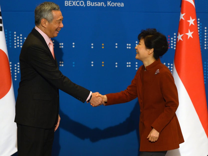 South Korea's President Park Geun-hye (R) shakes hands with Singapore's Prime Minister Lee Hsien Loong during their bilateral meeting at the ASEAN-Republic of Korea Commemorative Summit in Busan on Dec 11.  Photo: Reuters