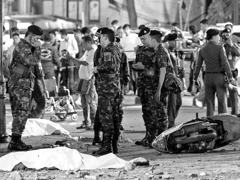 The body of a victim covered with a white sheet as security forces and emergency workers gather at the scene of the blast in Bangkok on Monday. The attack could be entirely unrelated to the ‘usual suspects’ of Thai violence, instead being the work of a small group or even a single individual with a specific grievance. Photo: Reuters