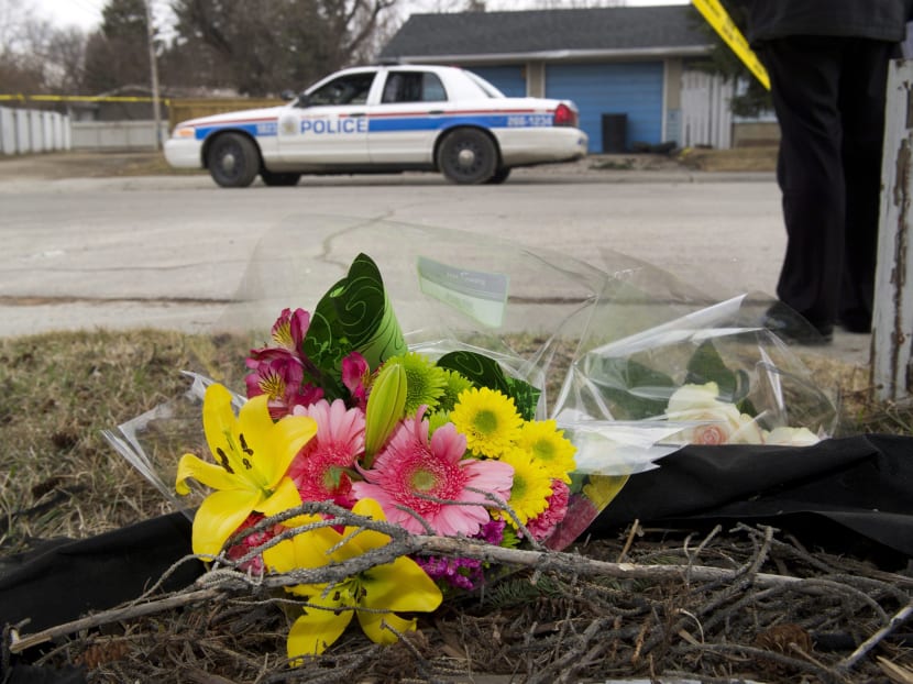 A makeshift memorial is left at police tape line near the scene of a multiple fatal stabbing in northwest Calgary, Alberta, on Tuesday, April 15, 2014. Calgary police say the son of one of their own is a suspect in the worst mass murder in the city's history, a bloody and baffling attack on a group of university students at a house party.  Photo: AP