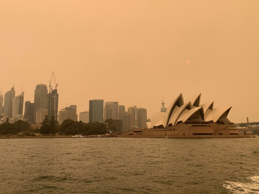 The haze from bushfires ringing Sydney obscures the sun setting above the Sydney Opera House in Sydney, Australia, Dec 6, 2019.