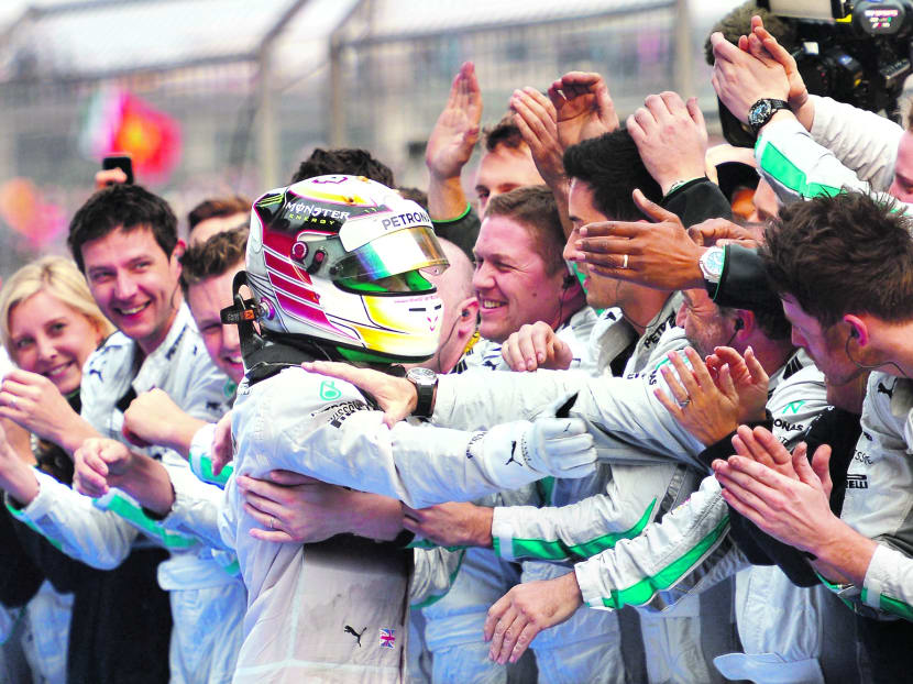 Lewis Hamilton celebrating his victory with his team following the Chinese Formula 1 Grand Prix at the Shanghai International Circuit yesterday. Photo: Getty Images