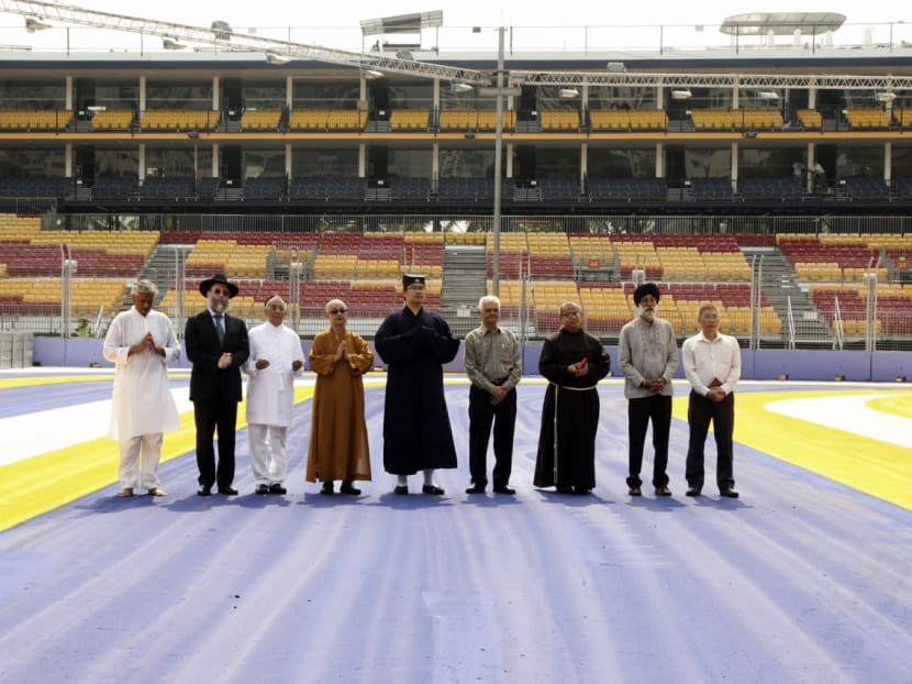 Religious leaders from different faith groups seen praying during a religious blessing ritual at the F1 Marina Bay Street Circuit yesterday morning.