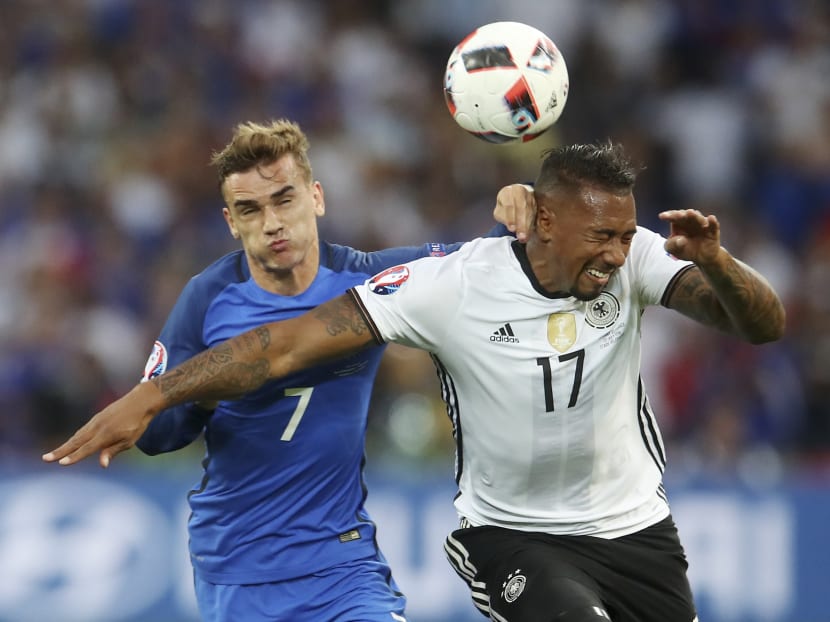 Germany's Jerome Boateng, right, challenges for the ball with France's Antoine Griezmann during the Euro 2016 semifinal between Germany and France, in Marseille, France, on Thursday, July 7. PHOTO: AP
