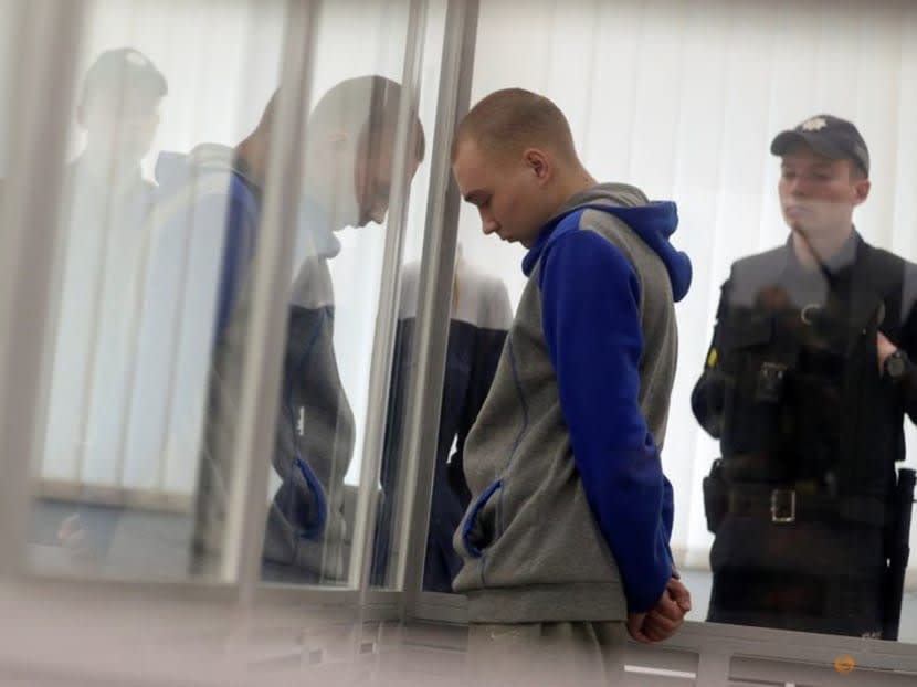 Russian soldier Vadim Shishimarin, 21, suspected of violations of the laws and norms of war, stands inside a cage during a court hearing, amid Russia's invasion of Ukraine, in Kyiv, Ukraine May 23, 2022.