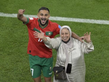 Morocco's midfielder Sofiane Boufal celebrating with his mother after the team defeated Portugal 1-0 in the Qatar 2022 World Cup quarter-final football match  on Dec 10, 2022.