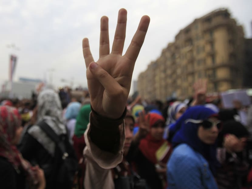 A protester gestures during a demonstration by pro-Mursi university students and supporters of the Muslim Brotherhood at Tahrir Square in Cairo on Dec 1, 2013. Photo: Reuters