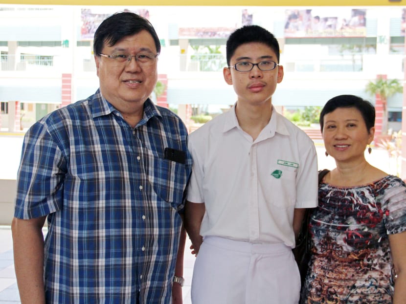 Joel Lee, who hopes to enter the science stream at Nanyang Junior College, with his parents today (Jan 12). Photo: Geneieve Teo