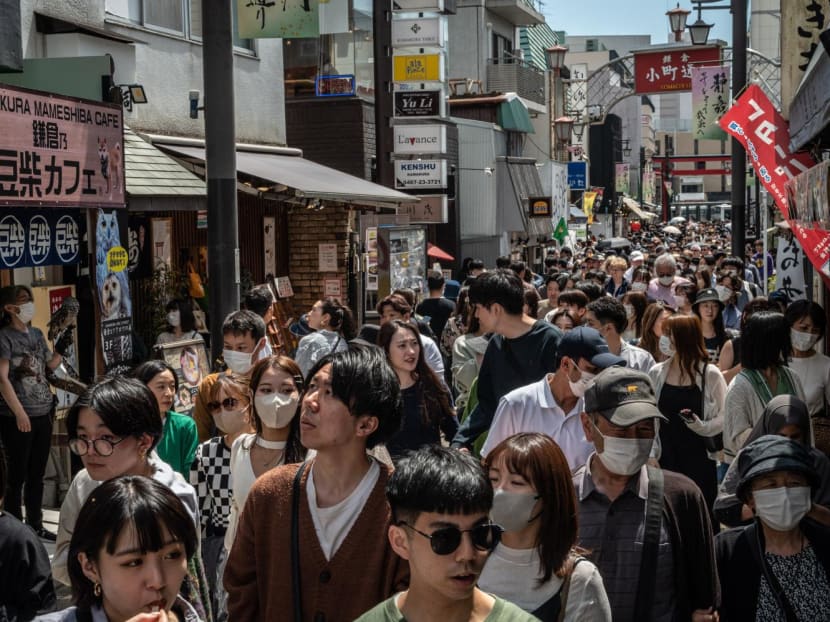 People walk through Komachidori shopping street in Kanagawa prefecture on May 3, 2023. 
