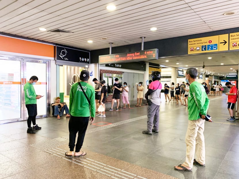 Delivery riders waiting and customers queueing for bubble tea from Koi at Yew Tee MRT Station on April 21, 2020 at about 9pm.