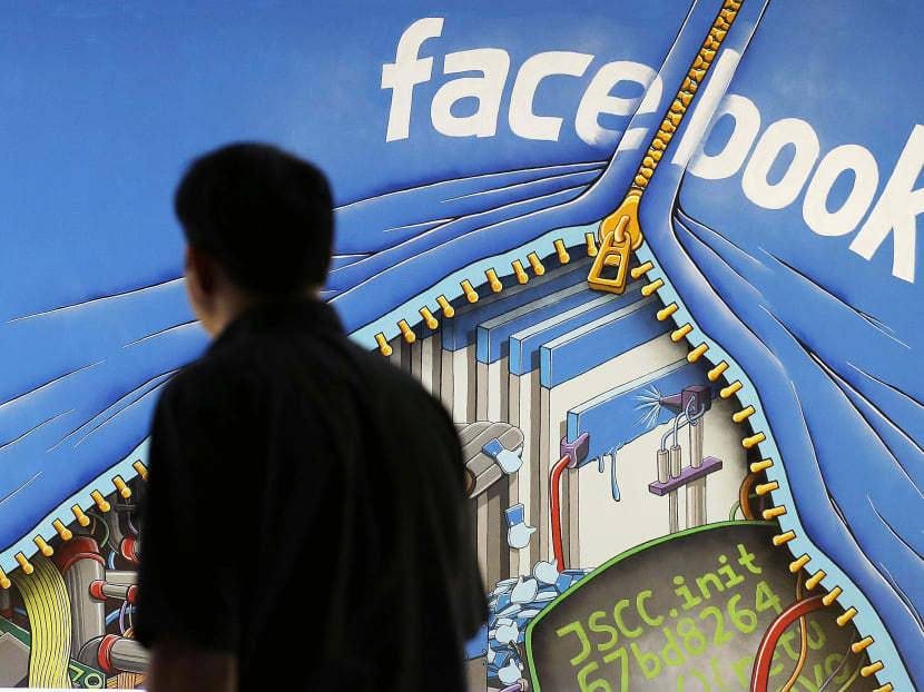 A man walks past a mural in an office on the Facebook campus in Menlo Park, Calif. Photo: AP