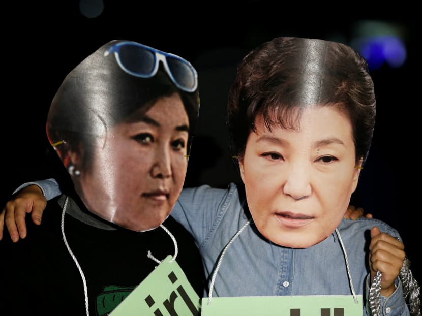 Protesters wearing cut-out of South Korean President Park Geun-hye (right) and Choi Soon-sil attend a protest denouncing President Park Geun-hye over a recent influence-peddling scandal. Photo: Reuters