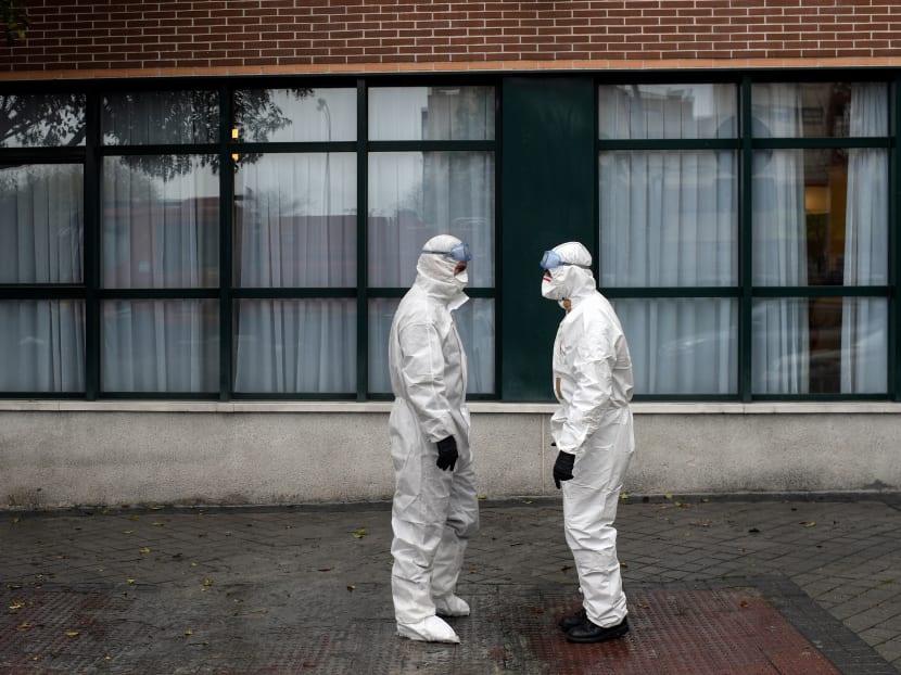 Members of the Military Emergencies Unit (UME) arrive to carry out a general disinfection at the Amavir residence for the elderly in Madrid on March 23, 2020.