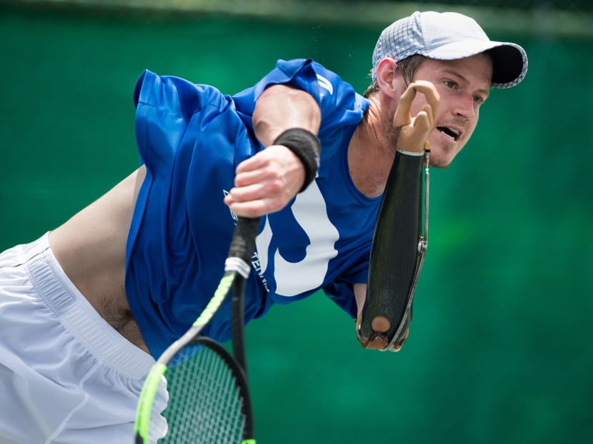 Alex Hunt following through on his serve during a training session with his coach in Bangkok. Photo: AFP
