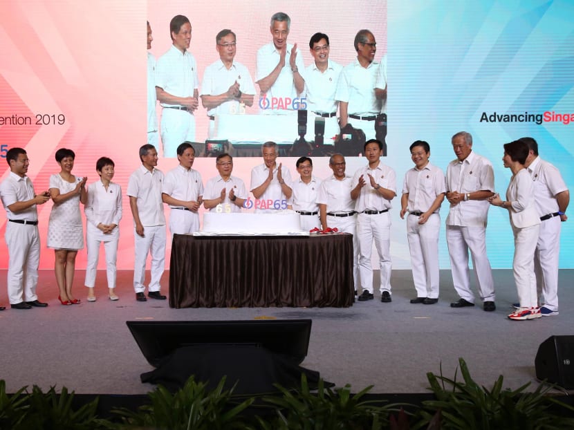 Prime Minister Lee Hsien Loong alongside Deputy Prime Minister Heng Swee Keat and other members of the PAP Central Executive Committee celebrating the party's 65th anniversary in November 2019.