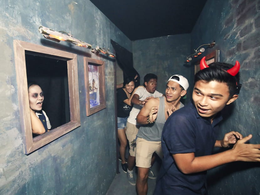 Guests making their way through a ‘haunted’ camp during the Halloween Horror Nights event at Universal Studios Singapore. 
PHOTO: RESORTS WORLD SENTOSA