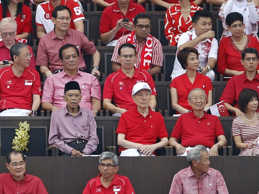 The remaining members of Singapore's first cabinet Othman Wok, Jek Yeun Thong and Ong Pang Boon are seen during NDP 2015 with a empty seat bearing a flower in memory of the late Mr Lee Kuan Yew. Photo: Raj Nadarajan/TODAY