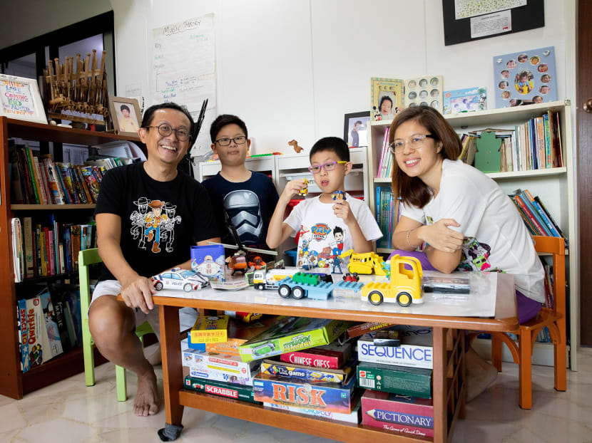 Mr Kelvin Seah, 51, with his wife Shaw Hui, 49, and their two children Caleb, 10, and Jaedon, 12, in their home.