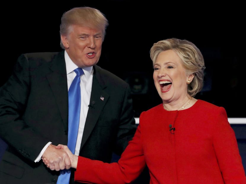Republican US presidential nominee Donald Trump shakes hands with Democratic US presidential nominee Hillary Clinton at the conclusion of their first presidential debate at Hofstra University in New York on Sept 26. The two have now packed their schedules with last-min campaign events before the presidential election that is just days away. Photo: Reuters