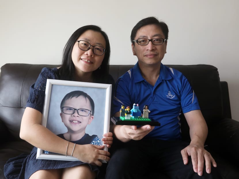 Mr William Lee and Mrs Winnie Lee with their son Raphael’s last gift to them, a Lego model of their family. The figure depicting Raphael is without a left arm.