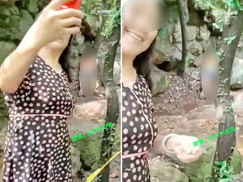 A tourist took selfies with the unconscious body of a woman who had reportedly fallen into a ditch in a nature park in Jiangsu province in China. 