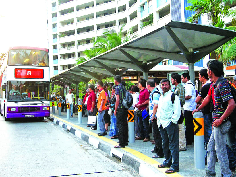Commuters waiting at a bus stop. TODAY file photo