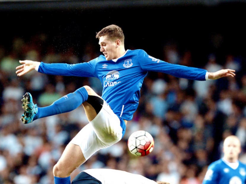 John Stones (in blue) tackling Harry Kane on Saturday. While Stones is a big part of Everton, it is clear to Tottenham that they cannot rely so heavily on Kane. Photo: AP