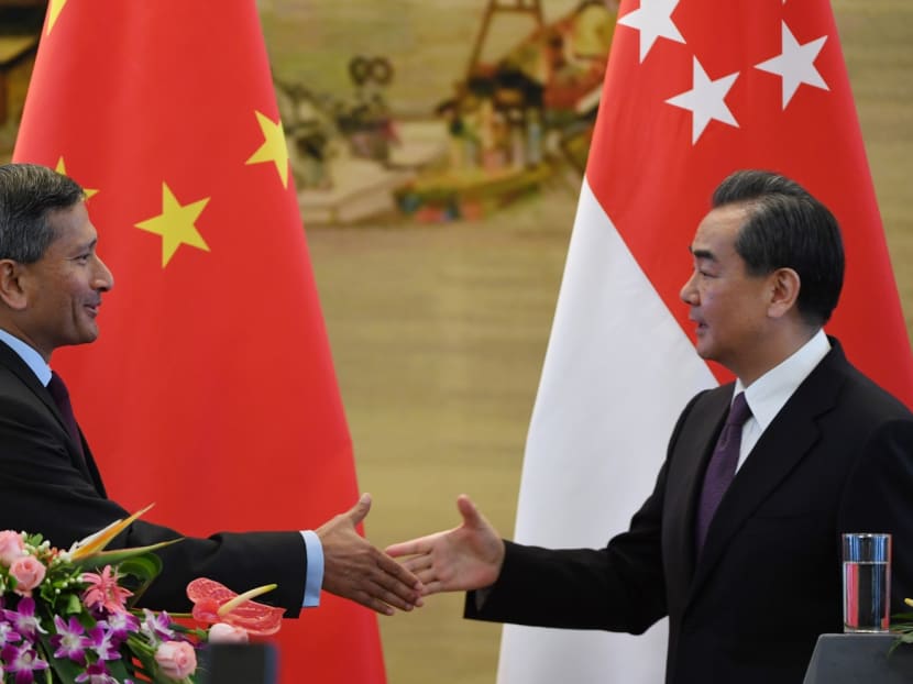 Singapore's Foreign Minister Vivian Balakrishnan (L) shakes hands with Chinese Foreign Minister Wang Yi during a joint press conference at the Ministry of Foreign Affairs in Beijing on June 12, 2017. Photo: AFP