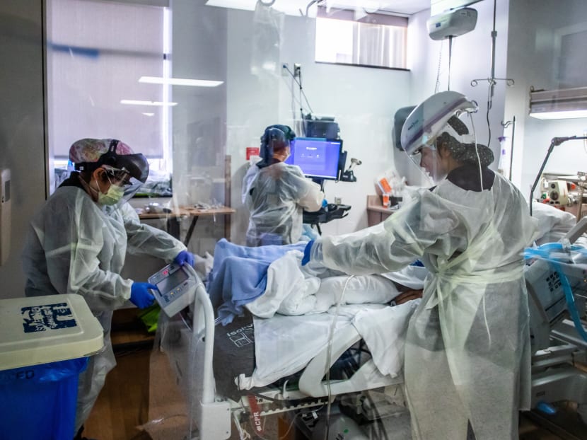 Nurses wearing personal protective equipment attend to a Covid-19 patient in the Intensive Care Unit at Providence Cedars-Sinai Tarzana Medical Center in Tarzana, California on Dec 18, 2020.