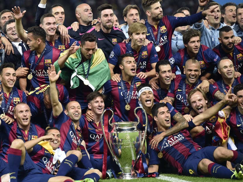 Barcelona players celebrate with the trophy after winning the 2014/15 Champions League final. Photo: AP