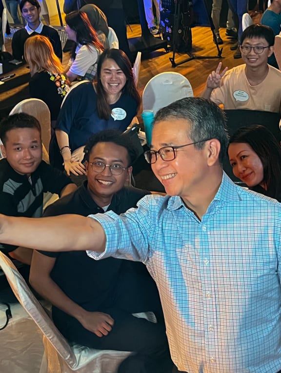 Mr Edwin Tong, Minister for Culture, Community and Youth, taking a selfie with participants of the National Youth Dialogue on May 24, 2023. 