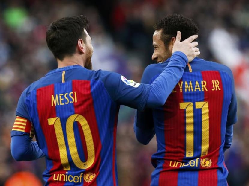 Barcelona's Lionel Messi sharing a light moment with teammate Neymar during a recent club game. Photo: Reuters