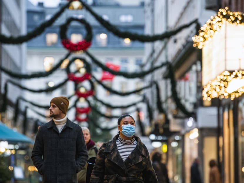 People walk past shops under Christmas decorations in Stockholm on Dec 3, 2020, during the novel coronavirus Covid-19 pandemic.