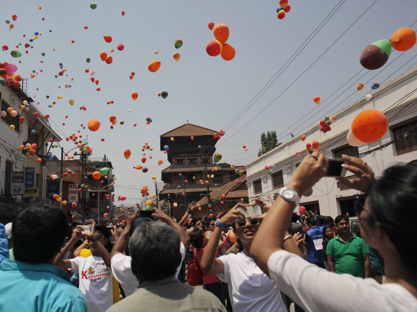 Nepalese people release balloons in memory of those who died in last year’s devastating earthquake in Kathmandu, Nepal, Saturday, April 23, 2016. Photo: AP