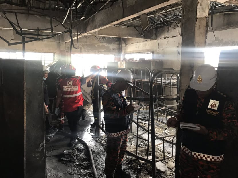 Malaysian Fire and Rescue personnel examining the charred interior of the second floor of the Darul Quran Ittifaqiyah religious school in Kuala Lumpur, Malaysia on Sept 14, 2017. Photo: Twitter/BombaJBPM