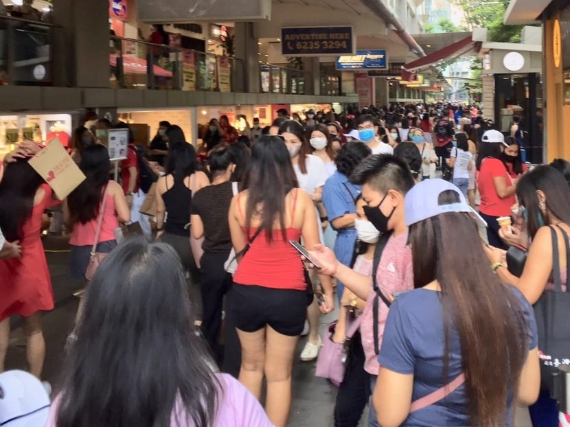 The writer saw this crowd outside Lucky Plaza on Aug 9.