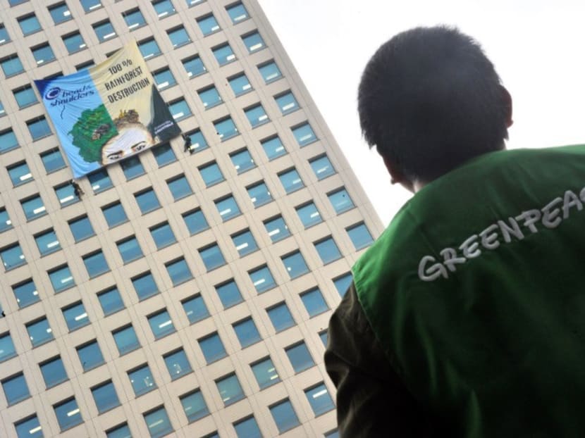 A banner reading "100% Rainforest Destruction" on a building during a Greenpeace demonstration in Jakarta in 2014. Photo: AFP