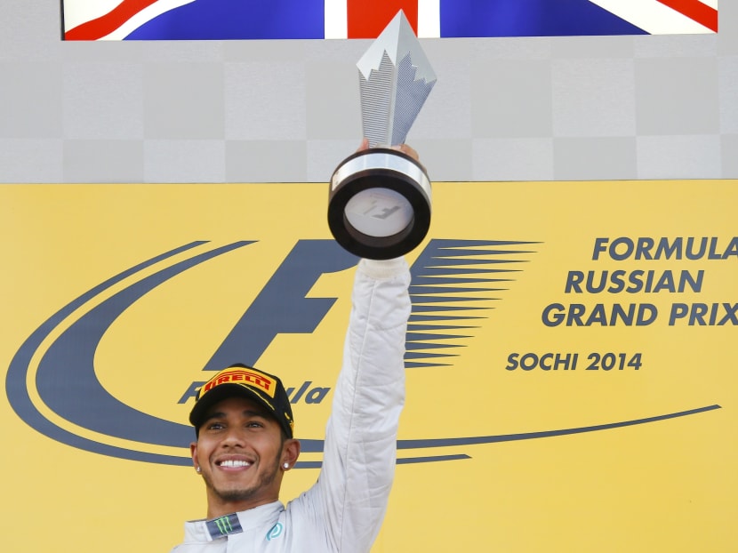 Mercedes Formula One driver Lewis Hamilton of Britain celebrates with the trophy after winning the first Russian Grand Prix in Sochi Oct 12, 2014.
 Photo: Reuters