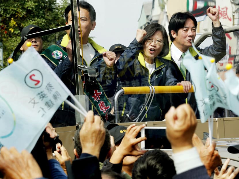 Taiwan’s Democratic Progressive Party presidential candidate Tsai Ing-wen, acknowledging supporters as she drove through the streets of Tainan yesterday. Dr Tsai is the clear frontrunner in the run-up to the election to be held on Saturday. Photo: AP