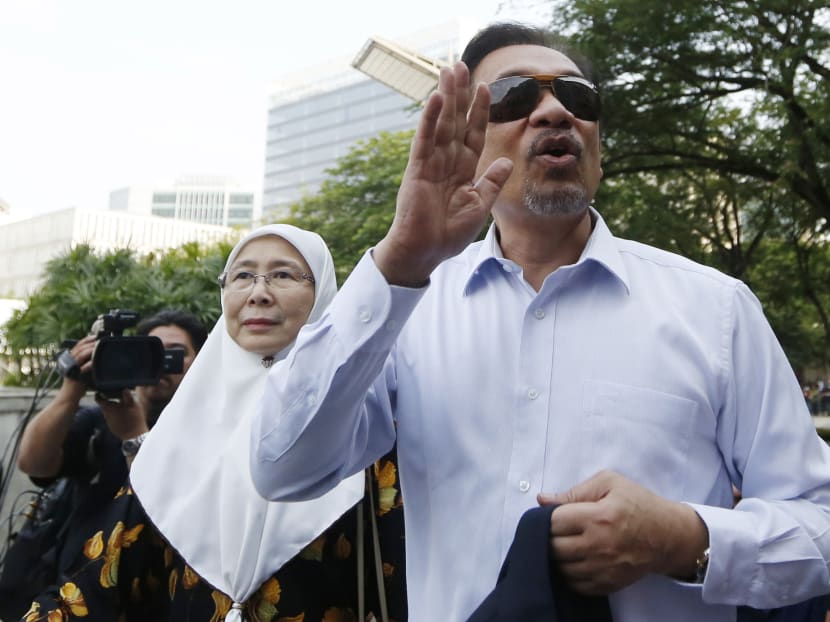Reuters file photo of Malaysia’s former opposition leader Anwar Ibrahim and wife Wan Azizah Wan Ismail in 2014.