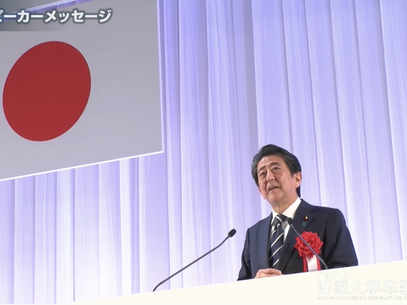 The late Shinzo Abe delivering a commencement speech at Kindai University's graduation ceremony on March 19, 2022.