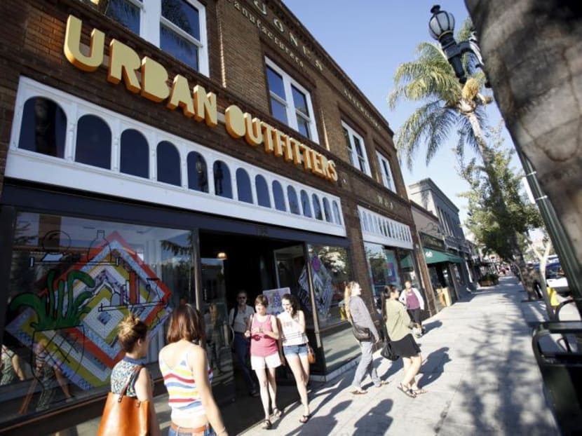 Shoppers are pictured outside an Urban Outfitters store in Pasadena, California. Urban Outfitters CEO Richard Hayne received the highest pay raise in 2014 compared to 2013. Reuters file photo