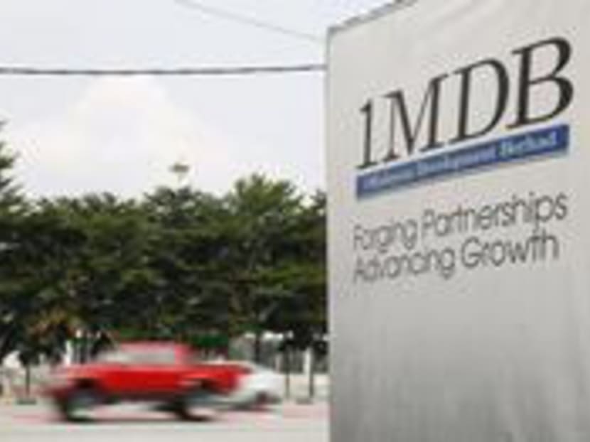 Vehicles passing a 1MDB billboard. Photo: Reuters