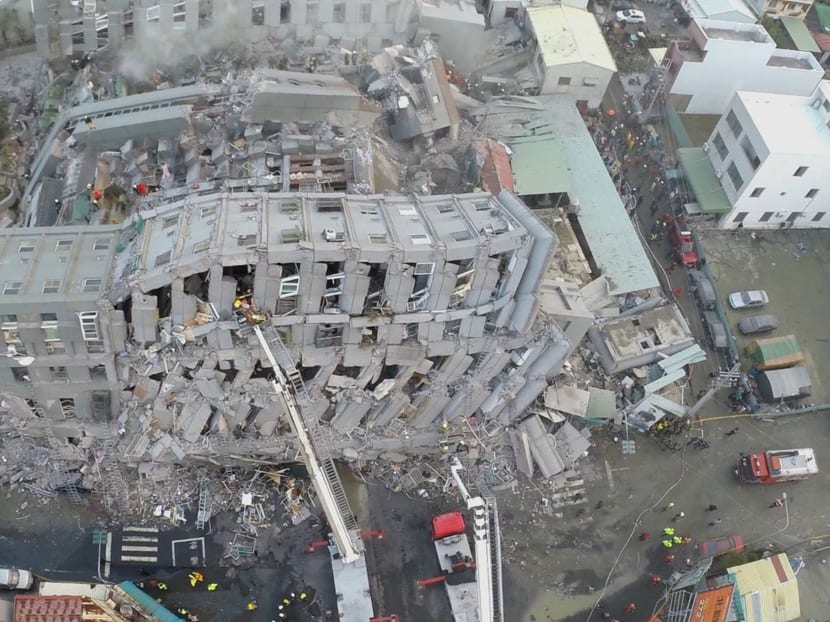 In this photo taken from a drone mounted camera, rescue workers search a collapsed building from an early morning earthquake in Tainan, Taiwan, Saturday, Feb. 6, 2016. A powerful, shallow earthquake struck southern Taiwan before dawn Saturday. Photo: AP