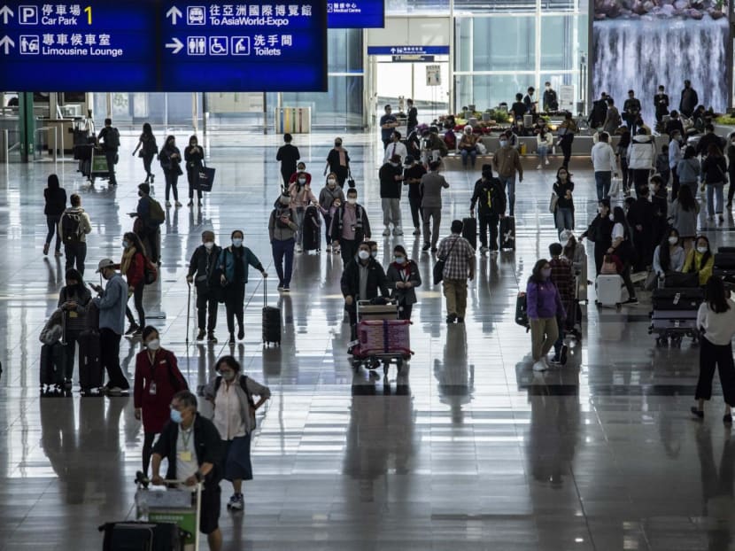 Passengers walk through the Hong Kong International Airport in Hong Kong on Dec 8, 2022.