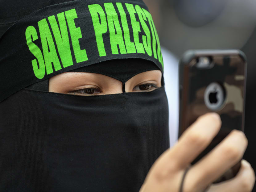 A Malaysian woman wearing a headband reading "Save Palestine" at a rally against US President Donald Trump's recognition of Jerusalem as Israel's capital, in Putrajaya, in 2017.