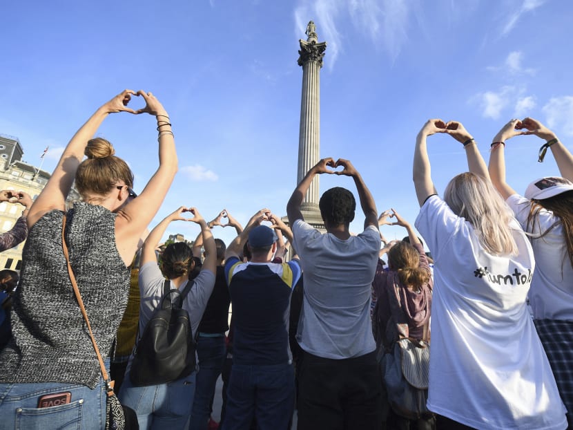 People gesture as they attend a vigil in Trafalgar Square, London Tuesday May 23, 2017 for the victims of the attack which killed over 20 people as fans left a pop concert by Ariana Grande in Manchester on Monday night. Photo: PA via AP