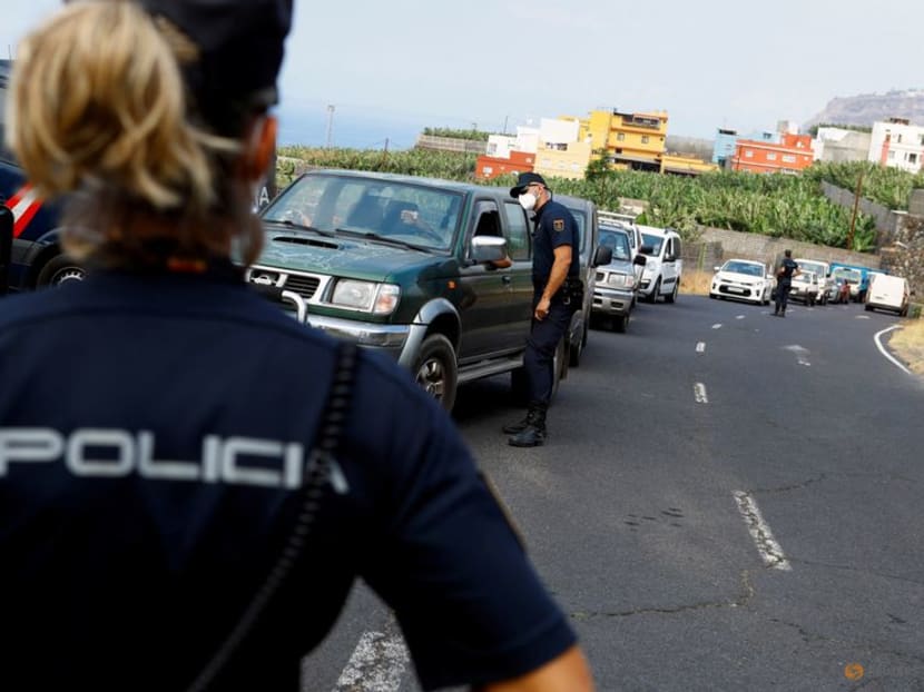 FILE PHOTO: A female police officer stands guard on the Canary Island of La Palma, in La Laguna, Spain, September 21, 2021. REUTERS/Borja Suarez/File Photo