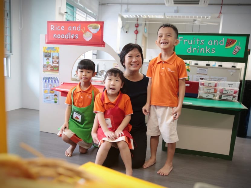 Assistant teacher Karina Lee with students at a Workforce Singapore event at My First Skool Toa Payoh yesterday. Ms Lee became an early childhood educator after having worked in IT for 17 years. Photo: Jason Quah