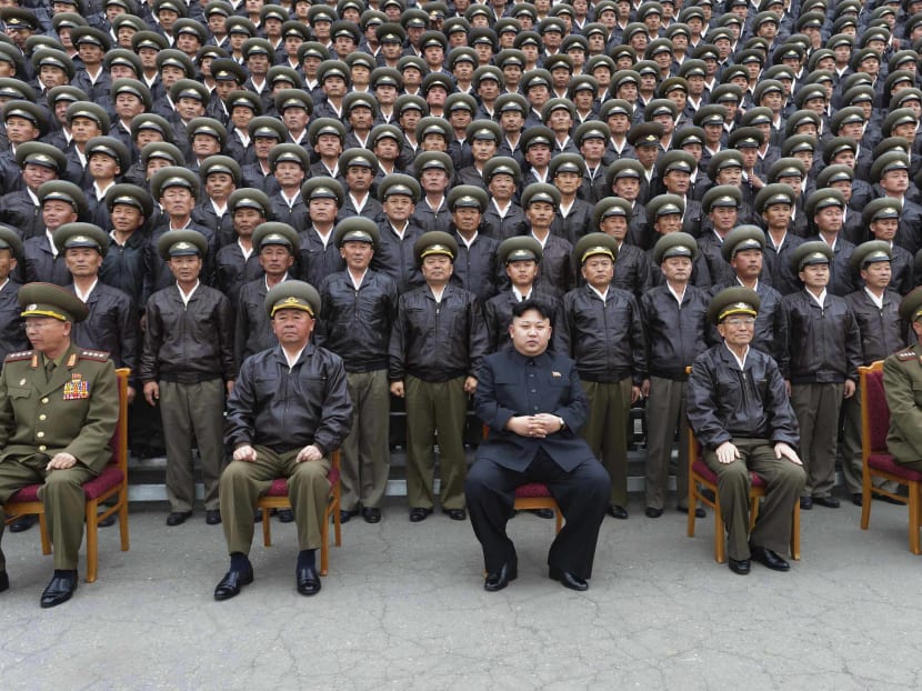 North Korean leader Kim Jong Un poses for a picture with senior military staff and other participants of the first meeting of the airpersons of the Korean People's Army (KPA) in Pyongyang April 17, 2014. Photo: Reuters